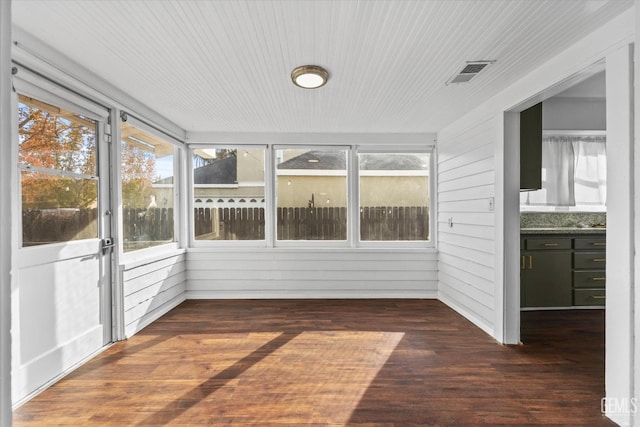 unfurnished sunroom featuring wooden ceiling and visible vents