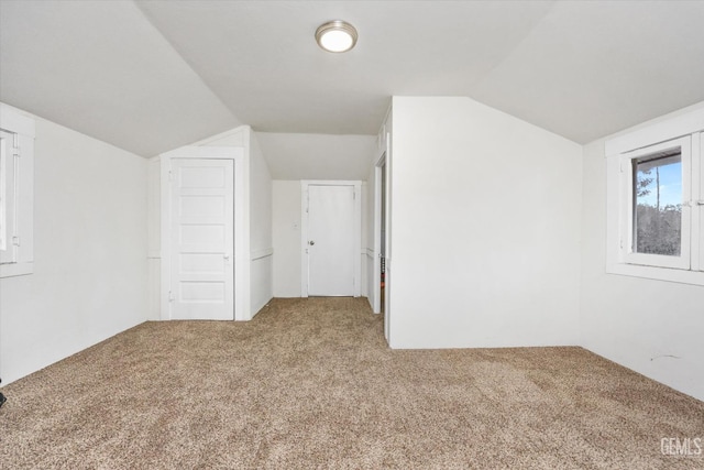 bonus room featuring lofted ceiling and carpet floors