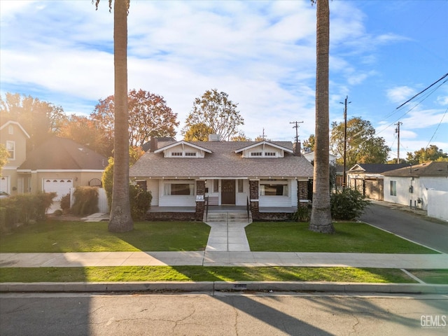 bungalow-style house with a shingled roof and a front lawn