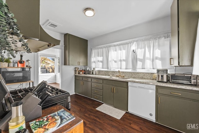 kitchen with black microwave, dark wood-type flooring, a sink, light countertops, and dishwasher