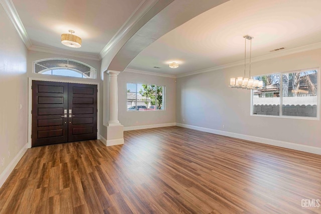 entryway with visible vents, decorative columns, wood finished floors, and baseboards