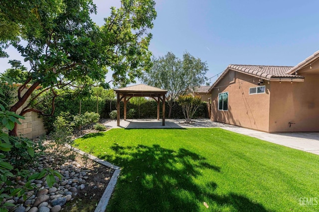 view of yard featuring fence, a gazebo, and a patio area