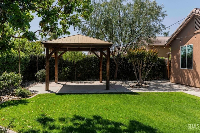 view of yard featuring fence, a gazebo, and a patio area