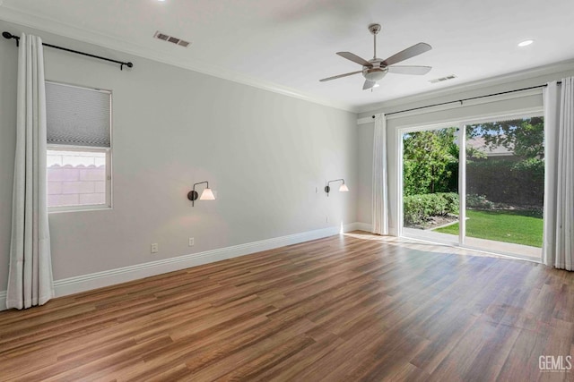 spare room featuring ornamental molding, visible vents, and a healthy amount of sunlight