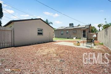 back of property featuring a patio area, roof mounted solar panels, a fenced backyard, and stucco siding