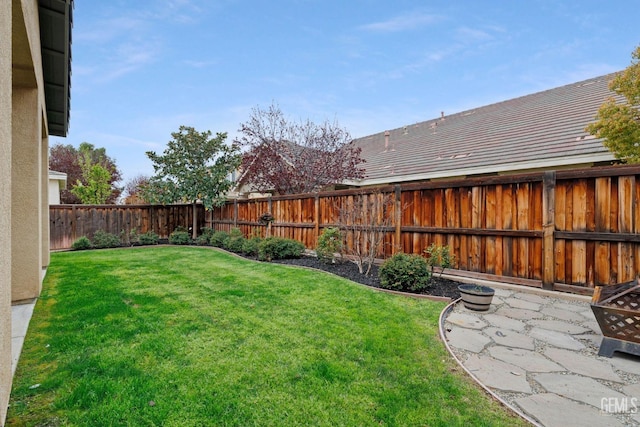 view of yard with a fenced backyard and a patio