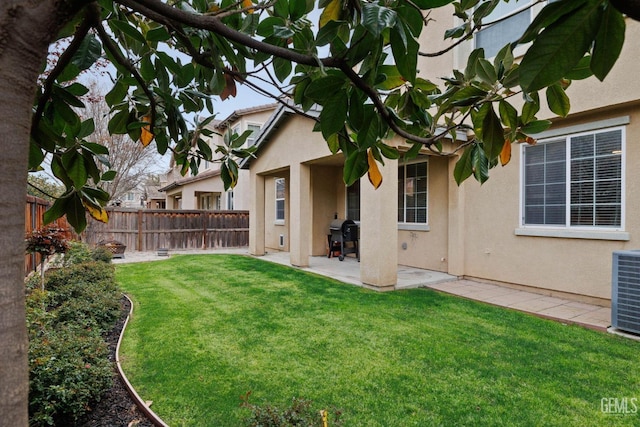 view of yard featuring a fenced backyard, a patio area, and cooling unit
