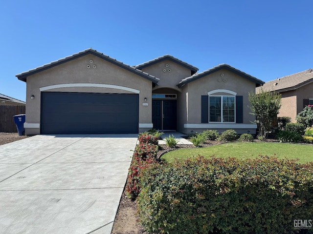 3317 Amazon Dr, Bakersfield, CA 93313 - view of front facade featuring stucco siding, an attached garage, driveway, a front yard, and a tile roof
