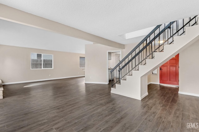 interior space featuring a textured ceiling, stairs, baseboards, and dark wood-type flooring