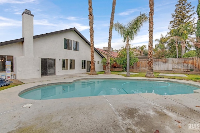 view of swimming pool with a patio area, fence, and a fenced in pool