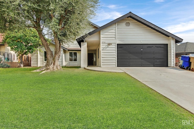 view of front of home featuring a front yard, concrete driveway, and an attached garage