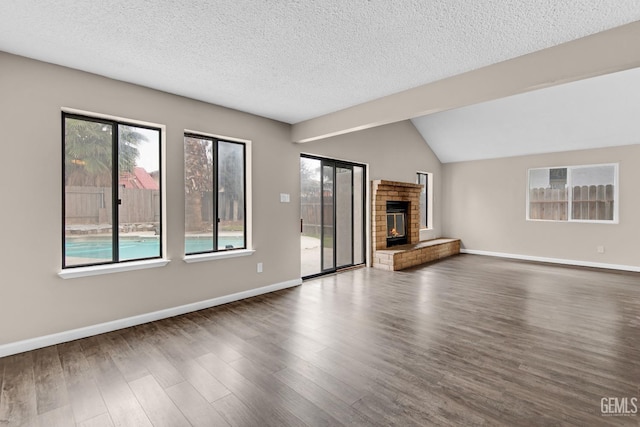 unfurnished living room with dark wood-style flooring, a fireplace, and baseboards