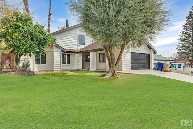 view of front of house featuring concrete driveway, a front lawn, and an attached garage