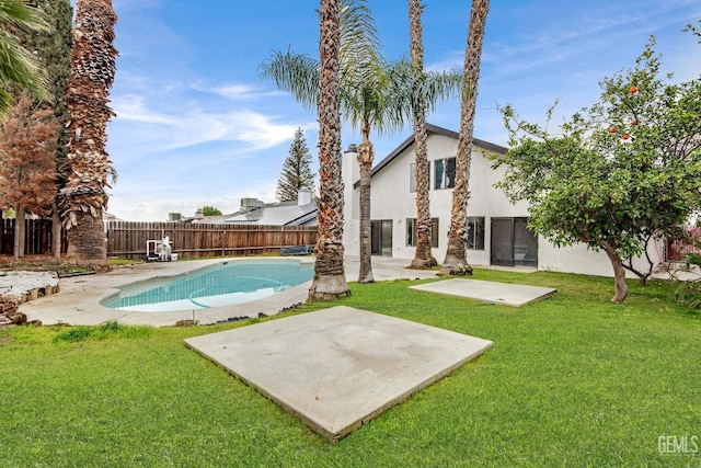 view of pool featuring a fenced in pool, a fenced backyard, a patio, and a lawn