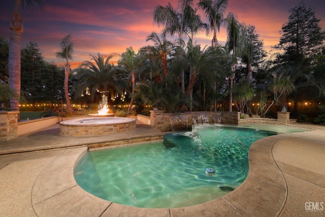 12603 Clay Creek Ct, Bakersfield, CA 93312 - pool at dusk featuring an outdoor pool, a patio, and an in-ground hot tub