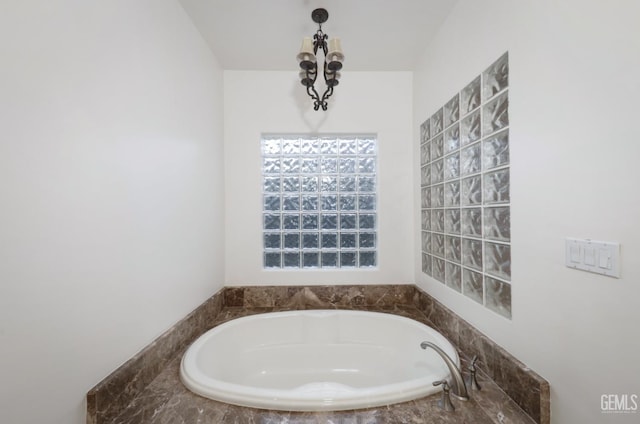 12603 Clay Creek Ct, Bakersfield, CA 93312 - bathroom featuring a bath and a chandelier