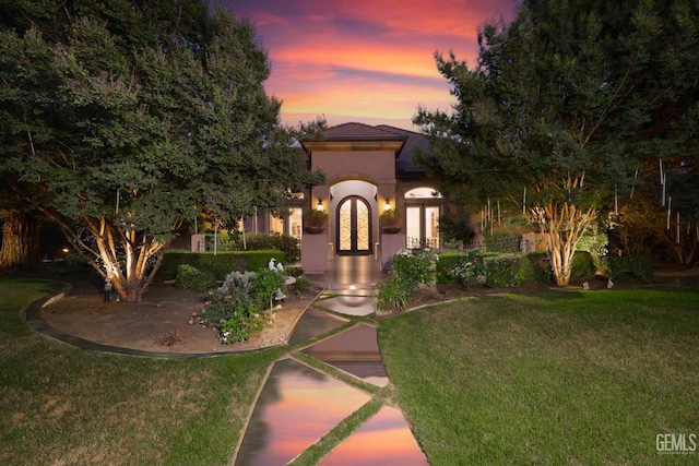 12603 Clay Creek Ct, Bakersfield, CA 93312 - mediterranean / spanish-style house featuring french doors, stucco siding, a yard, and a tile roof