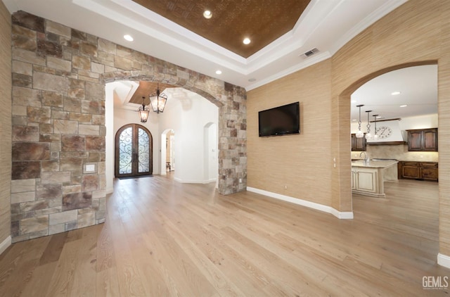 12603 Clay Creek Ct, Bakersfield, CA 93312 - foyer featuring arched walkways, a tray ceiling, recessed lighting, light wood-style floors, and ornamental molding