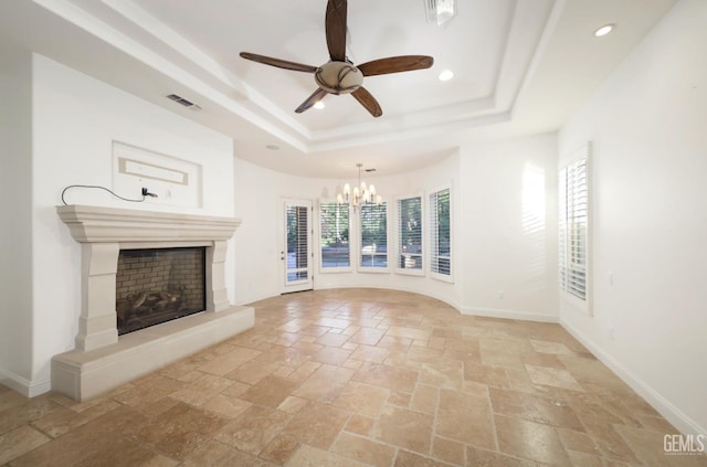 12603 Clay Creek Ct, Bakersfield, CA 93312 - unfurnished living room featuring a tray ceiling, stone tile flooring, plenty of natural light, recessed lighting, and a chandelier
