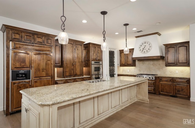12603 Clay Creek Ct, Bakersfield, CA 93312 - kitchen featuring stainless steel appliances, recessed lighting, backsplash, light stone counters, and wood finished floors
