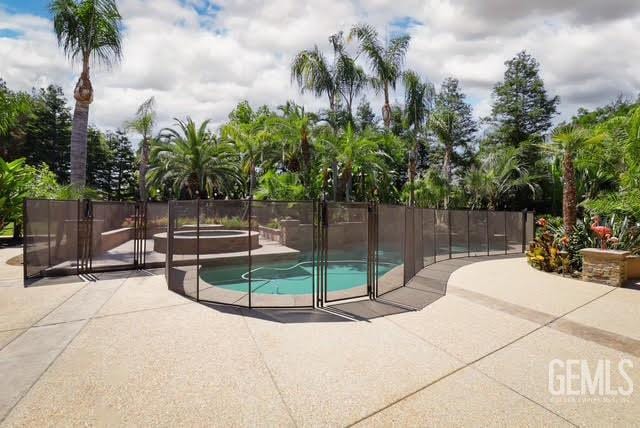 12603 Clay Creek Ct, Bakersfield, CA 93312 - view of pool featuring a jacuzzi and a patio