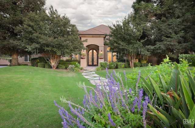 12603 Clay Creek Ct, Bakersfield, CA 93312 - view of front of house with a front lawn, stucco siding, french doors, and a tiled roof