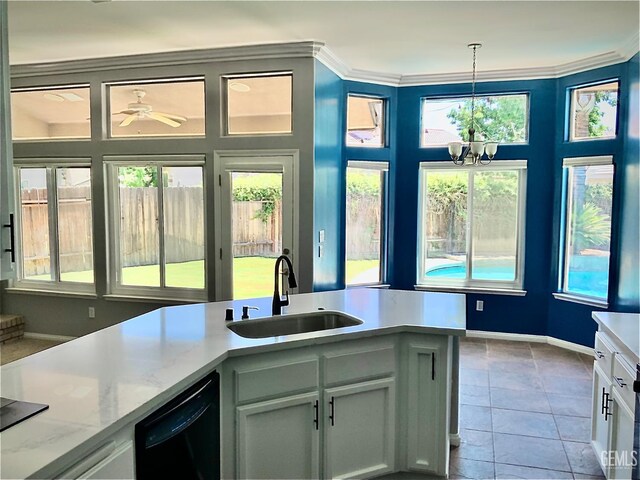5322 Windriver Dr, Bakersfield, CA 93312 - kitchen featuring black dishwasher, a chandelier, healthy amount of natural light, decorative light fixtures, and crown molding