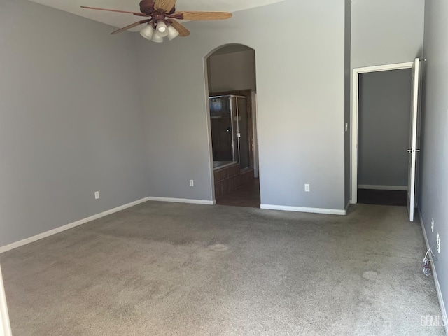 5322 Windriver Dr, Bakersfield, CA 93312 - unfurnished bedroom featuring arched walkways, carpet flooring, ensuite bath, and ceiling fan