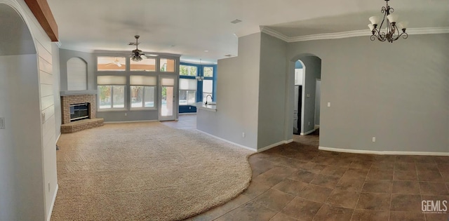 5322 Windriver Dr, Bakersfield, CA 93312 - unfurnished living room with ceiling fan, arched walkways, crown molding, a fireplace, and dark carpet