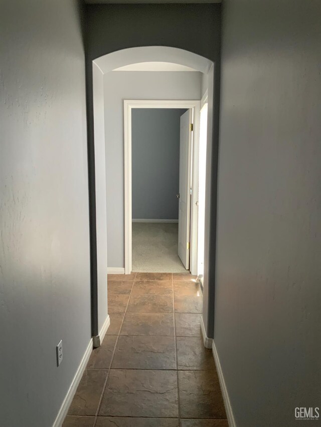 5322 Windriver Dr, Bakersfield, CA 93312 - hall with arched walkways and stone tile floors