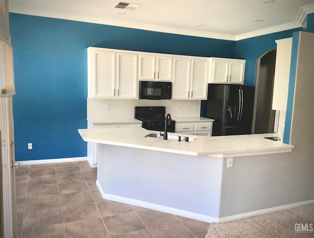5322 Windriver Dr, Bakersfield, CA 93312 - kitchen with black appliances, white cabinets, arched walkways, light countertops, and crown molding