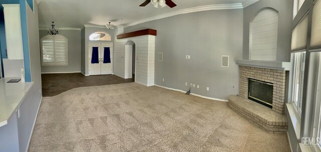 5322 Windriver Dr, Bakersfield, CA 93312 - unfurnished living room featuring a fireplace, a ceiling fan, carpet flooring, ornamental molding, and arched walkways