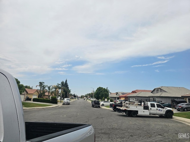 4102 Sierra Redwood Dr, Bakersfield, CA 93313 - view of asphalt street with curbs, sidewalks, a residential view, and street lighting