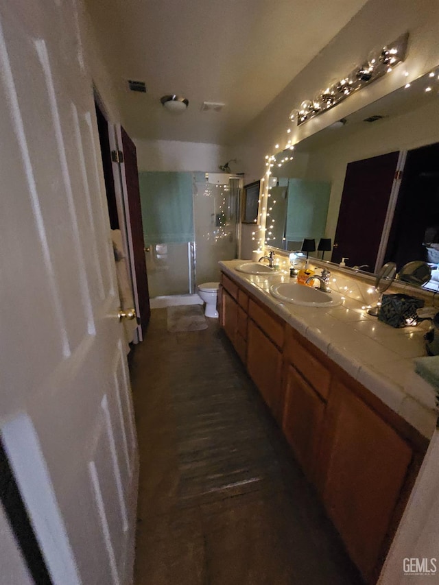 4102 Sierra Redwood Dr, Bakersfield, CA 93313 - bathroom featuring a shower stall, double vanity, and wood finished floors