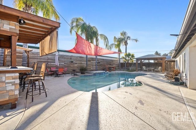 view of swimming pool with a fenced in pool, outdoor dry bar, a gazebo, a patio area, and a fenced backyard