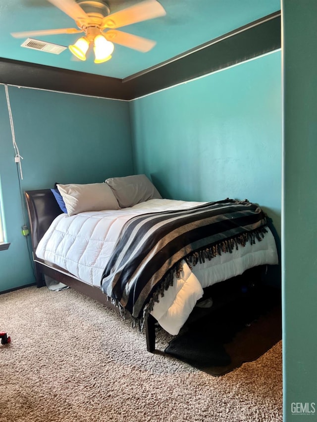 bedroom featuring visible vents, a ceiling fan, and carpet