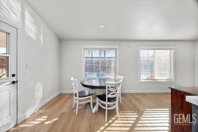 dining room with light wood finished floors and baseboards