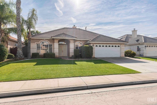 view of front of property featuring a garage and a front yard