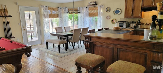 5308 Benevento Ct, Bakersfield, CA 93308 - interior space featuring brown cabinets, a wealth of natural light, a toaster, and decorative backsplash