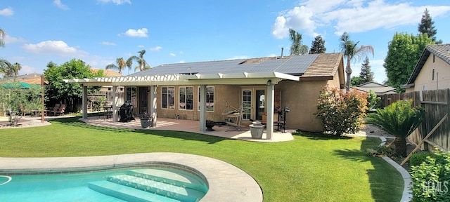 5308 Benevento Ct, Bakersfield, CA 93308 - back of property featuring a yard, solar panels, a fenced backyard, and stucco siding