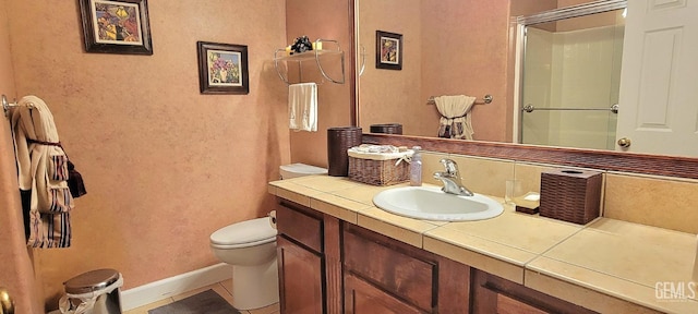 5308 Benevento Ct, Bakersfield, CA 93308 - bathroom with tile patterned floors, vanity, baseboards, toilet, and an enclosed shower