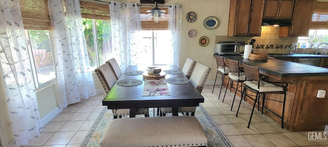 5308 Benevento Ct, Bakersfield, CA 93308 - dining area with baseboards, a toaster, and light tile patterned floors