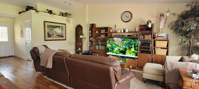 5308 Benevento Ct, Bakersfield, CA 93308 - living area featuring vaulted ceiling, arched walkways, and wood finished floors