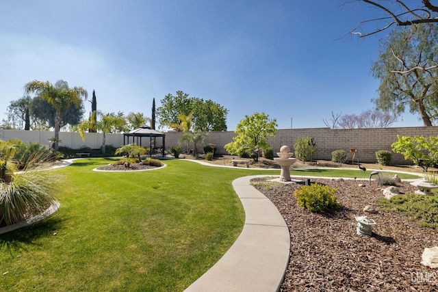 view of yard featuring a gazebo and a fenced backyard