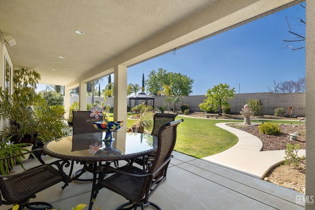 view of patio with outdoor dining area and a fenced backyard