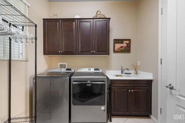 laundry area featuring a sink, cabinet space, and washing machine and clothes dryer