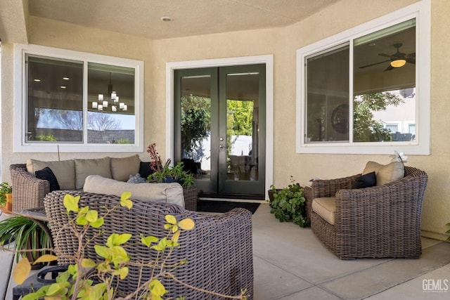 view of exterior entry with outdoor lounge area, a patio, french doors, and stucco siding