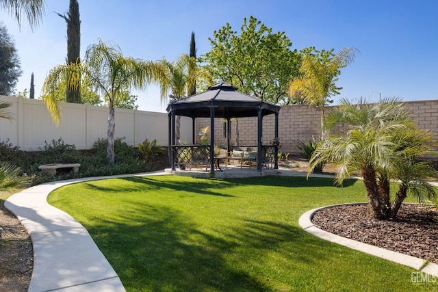 view of community featuring a gazebo, a lawn, a patio, and a fenced backyard