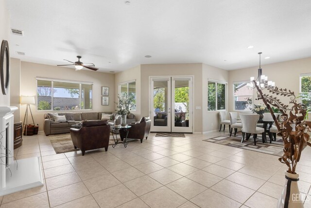 living area featuring light tile patterned floors, a healthy amount of sunlight, and visible vents