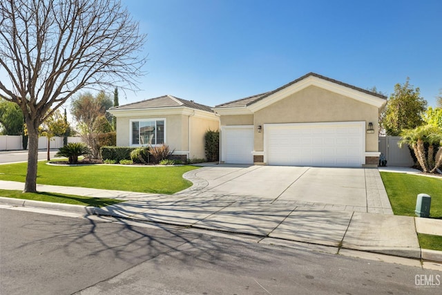 ranch-style house featuring fence, stucco siding, concrete driveway, a front lawn, and a garage